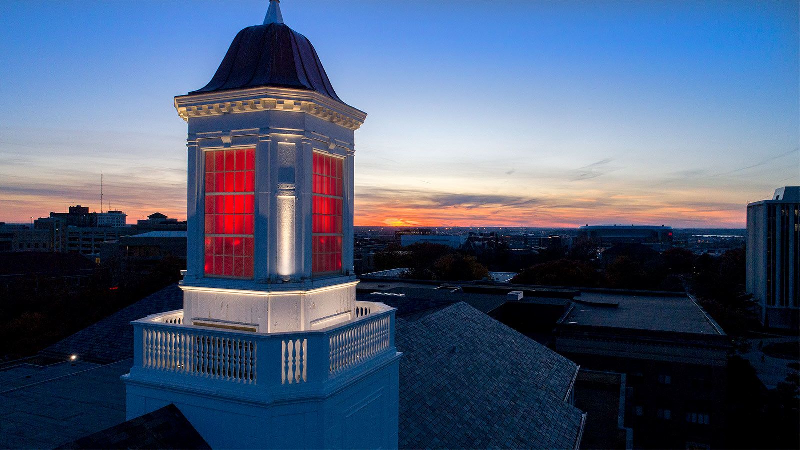 The cupola on top of Love Library lit up red