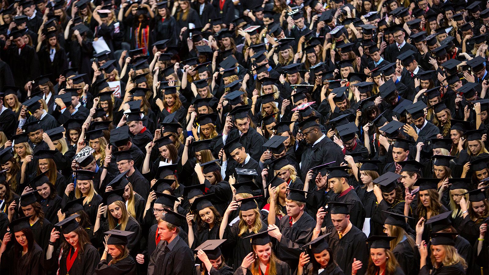 large crowd of students in graduation cap and gowns 