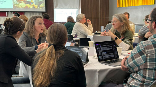 group at table with laptop