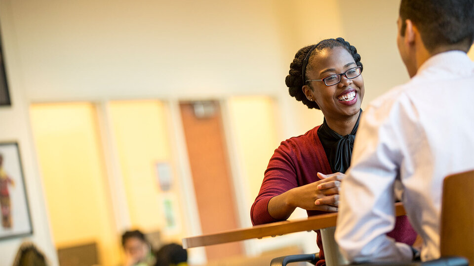 Staff members chatting in the Gaughan Center