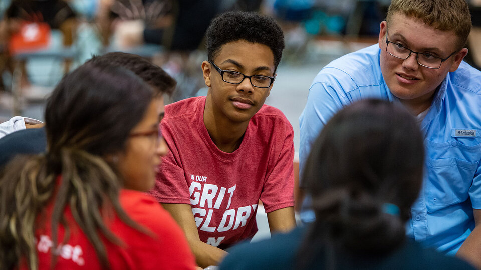 students in groups communicating