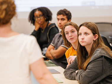 Katrina Jagodinsky, Associate Professor of History (standing), talks with the summer group