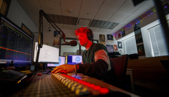 Ryan Luetkemeyer, a student from St. Louis, does the afternoon broadcast from the booth at KRNU Nov. 9, 2022. 