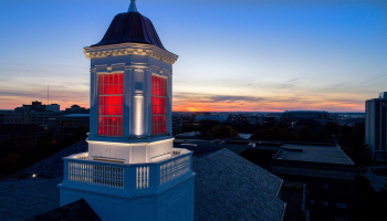 The cupola on top of Love Library lit up red